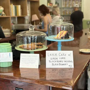a counter with cakes and other items