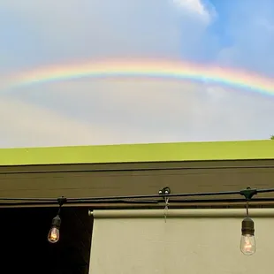 a rainbow in the sky over a building