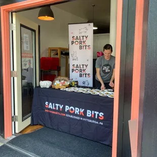 a man standing behind a table