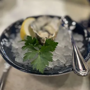 a plate of oyster and a lemon wedge