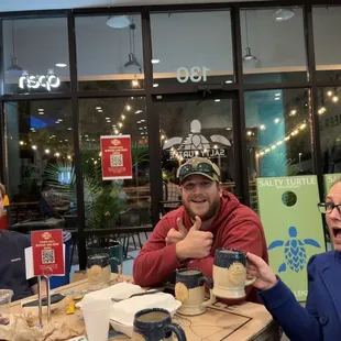 three people sitting at a table