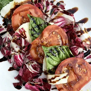Burrata Salad: Tomatoes, radicchio, basil, mozzarella, balsamic reduction, basil oil | $10.95