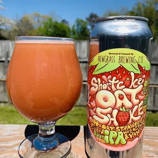 a glass and a can of salud beer