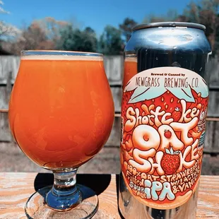 a glass and a can on a table