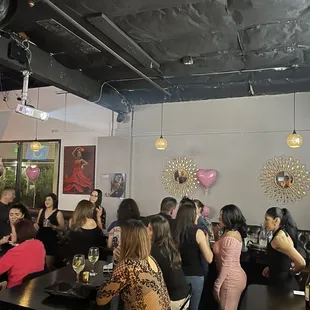 a large group of people sitting at a bar