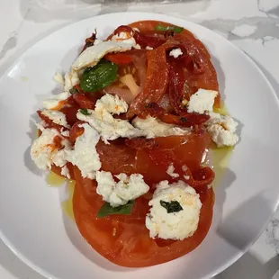a plate of tomatoes and cheese