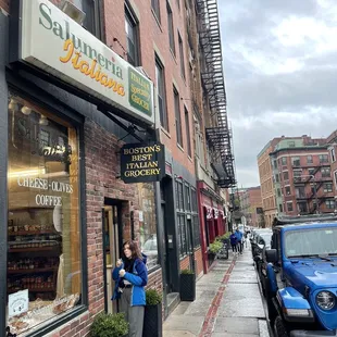 a woman standing outside a restaurant