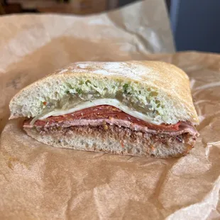 Muffo: House-made mortadella, hot sopressata, Calabrian chili tapenade, provolone, roasted onions