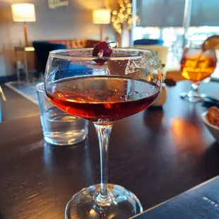 a glass of wine on a bar