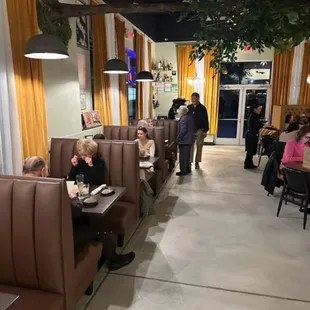 people sitting at tables in a restaurant