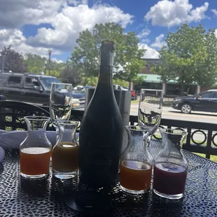 Prosecco bottle and four juices