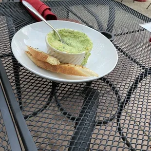 Spinach Artichoke dip with crispy bread delicately sliced
