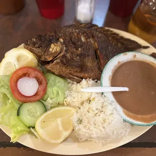 a plate of fish, rice and vegetables