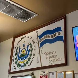 a television and a sign on the wall