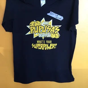 a black t - shirt with the words,'what's your superpower? '