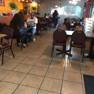 people sitting at tables in a restaurant