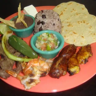 Churrasco-Carne Asada, Chorizo Salvadoreno, Grilled Shrimp, Casamiento (Marriage of the beans and rice), beans, fried plantain