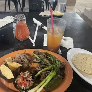Carne asada with casamiento (beans and rice), served with a side of corn tortillas