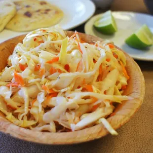 Curtido, this is a pickled relish that you scoop on top of your pupusa and top with your choice of hot sauce or alone
