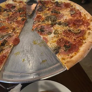 a half eaten pizza on a serving tray