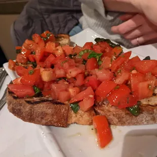 a piece of bread with tomatoes on it