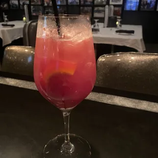 a glass of wine with a straw