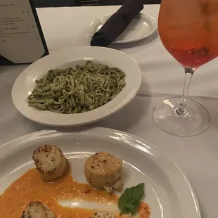 Pesto pasta and scallops with red pepper sauce