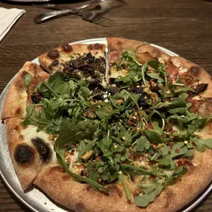 FIGGY PIGGY Whole Milk Mozzarella, Wine Poached Figs, Prosciutto, Pistachios, MontAmore and Bleu Cheese finished with Arugula &amp; Spicy Honey.