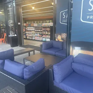 blue couches and tables in front of a store