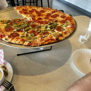 Half pepperoni and half pepperoni, mushrooms, jalapeños