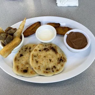 Combo #1: Pupusas mixtas, Yucca, Chicharrón, Plantains, Salvi Cream and beans.