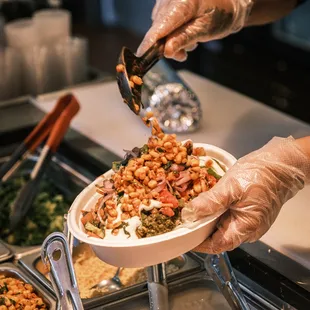 Adding corn in our curry bowl!