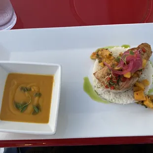 Mahi Mahi with Mango in a coconut yam cream sauce and an avocado cream sauce on a bed of rice