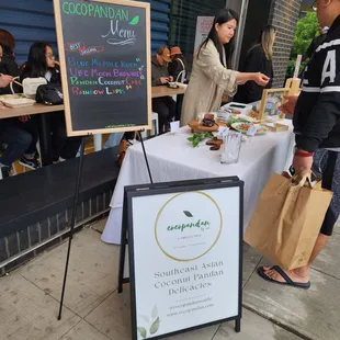 a table with food and a sign