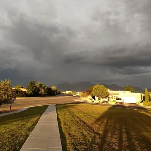 Rain clouds over the Organ Mountains and Sunshine behind.