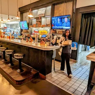 a woman standing at the bar