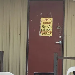 a happy hour sign on a door