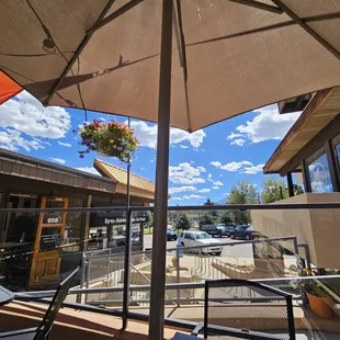 a patio area with tables and umbrellas
