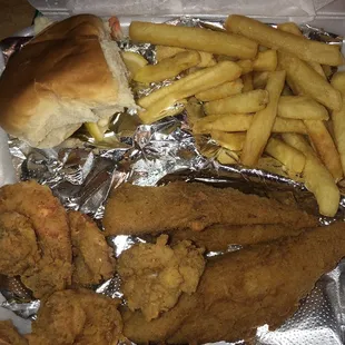 Hot fish and shrimp and fries on foil