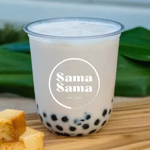 a glass of milk and a piece of cheese