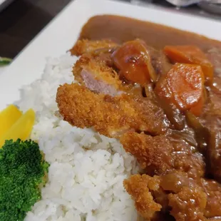 a plate of food with rice and broccoli