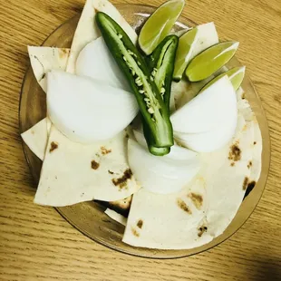 a tortilla with onions and sliced peppers