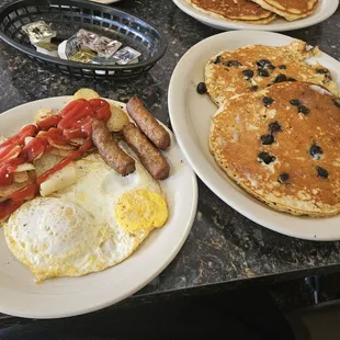 Sausage, eggs, and home fries with blueberry Pancakes