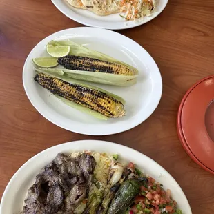 Carne azada and pupusas and Grilled corn on the cob