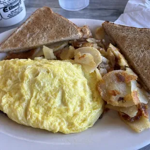 Sausage, mushroom, and cheddar omelette with sliced home fries.