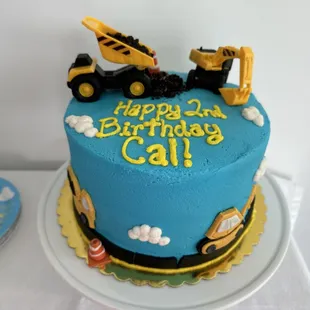 a birthday cake with construction vehicles