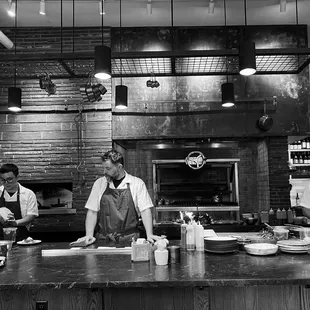 three chefs in a kitchen preparing food