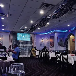 View of the restaurant from the back corner. The TV showed a slide show of photos of Samarkand