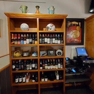 a shelf full of wine bottles