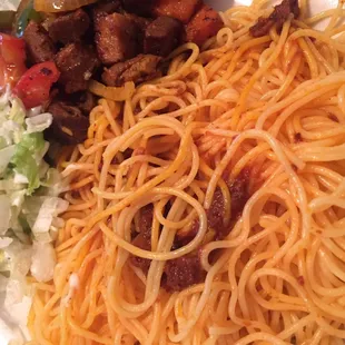 Baasto (spaghetti and tomato sauce), suqaar (beef chunks) and salad. This is a home plate as it was a to-go order